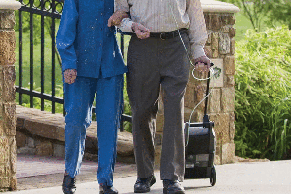 Oxlife Independence Oxygen Concentrator walking couple